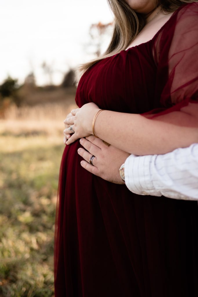 during this luxury maternity photoshoot the expecting couple rest their hands on her belly as the photographer captures her pregnant figure