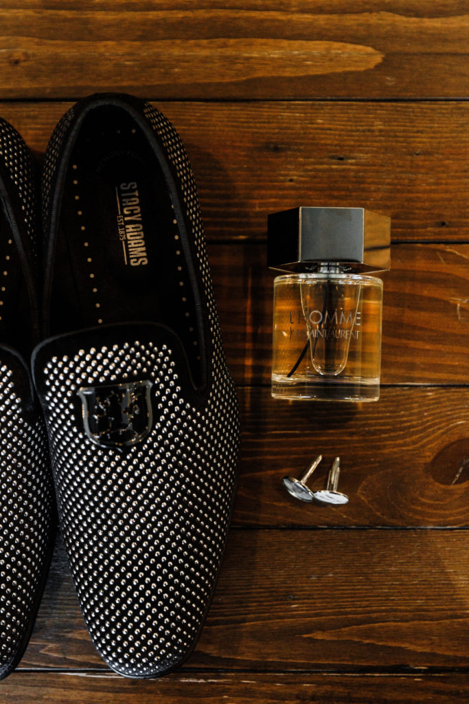 the groom's shoes rest next to his wedding day cologne and cufflinks, laid out for timeless wedding photography