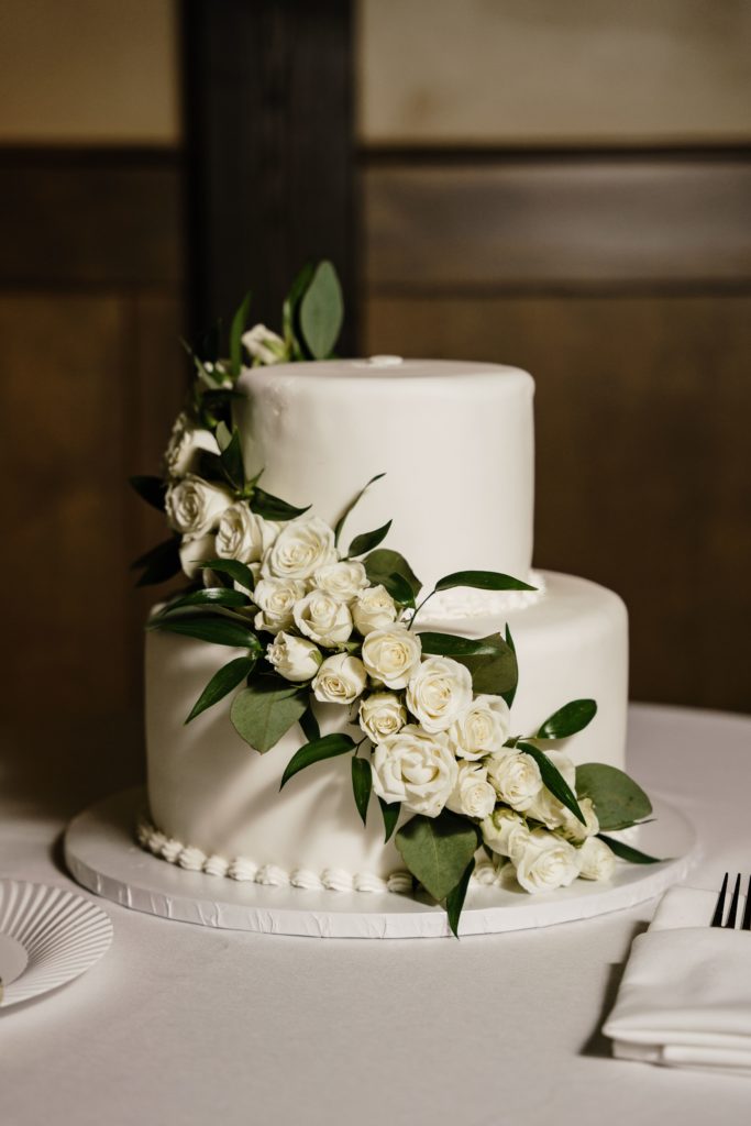 a timeless wedding photography portrait of the white rose lined wedding cake