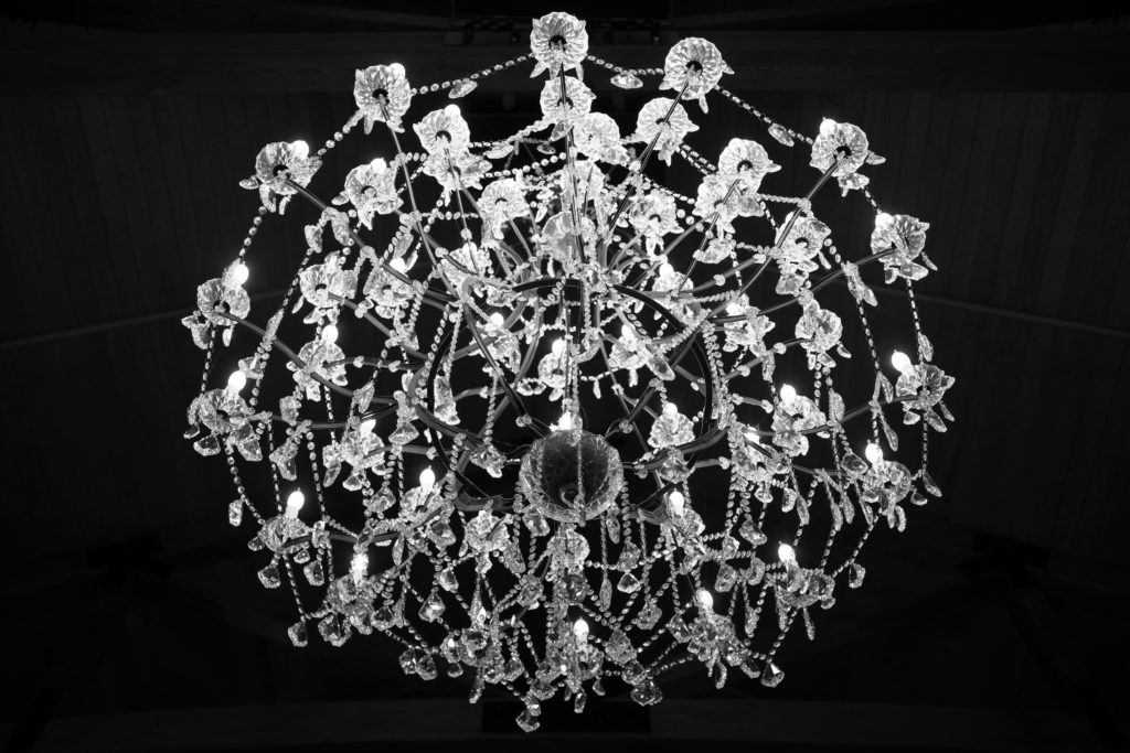 a dramatic portrait of a chandelier at black river barn in south haven michigan