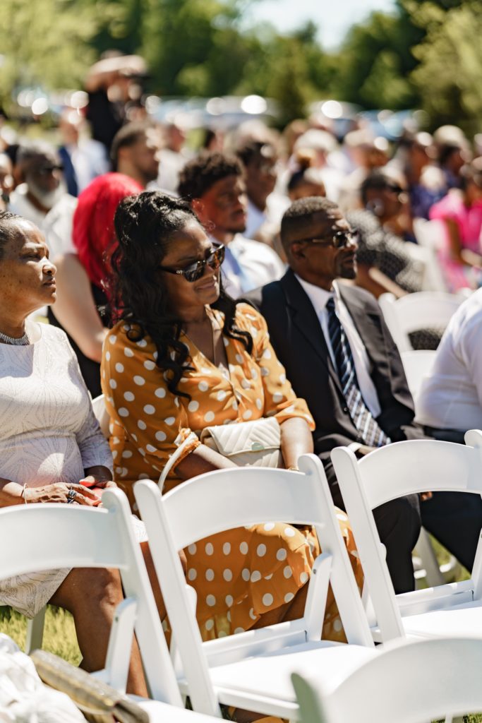 luxury wedding photography of wedding guests looking attentively as the wedding ceremony unfolds in front of them