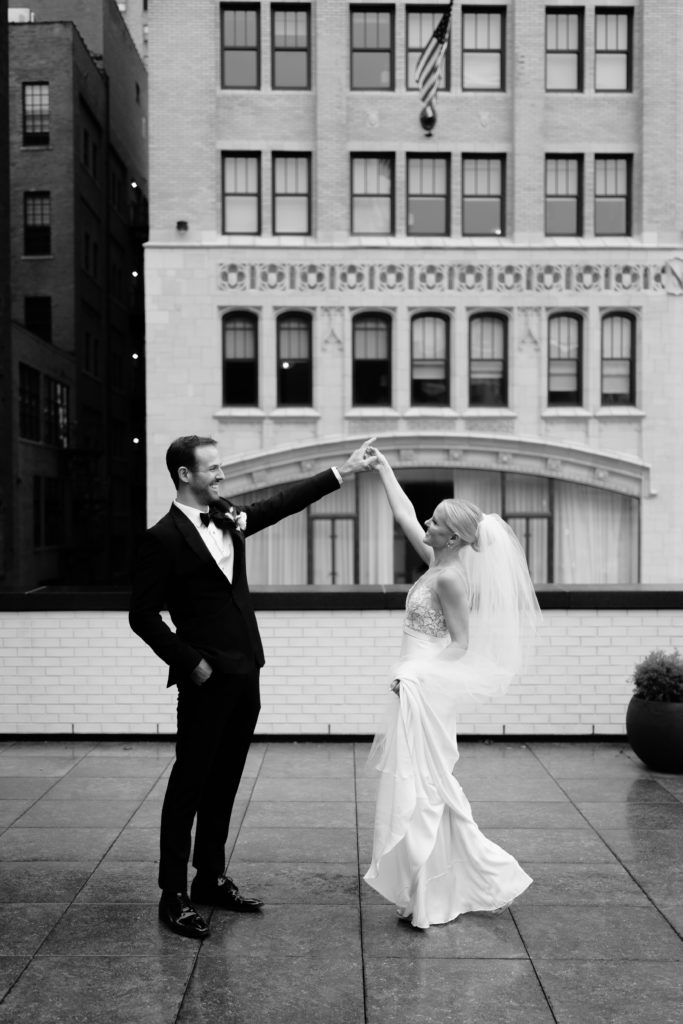 the bride and groom dance on the roof and are captured by a detroit wedding photographer