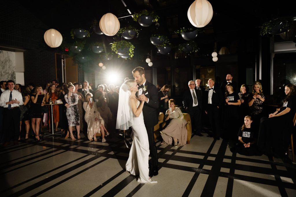 the bride and groom share a dance at their shinola hotel wedding