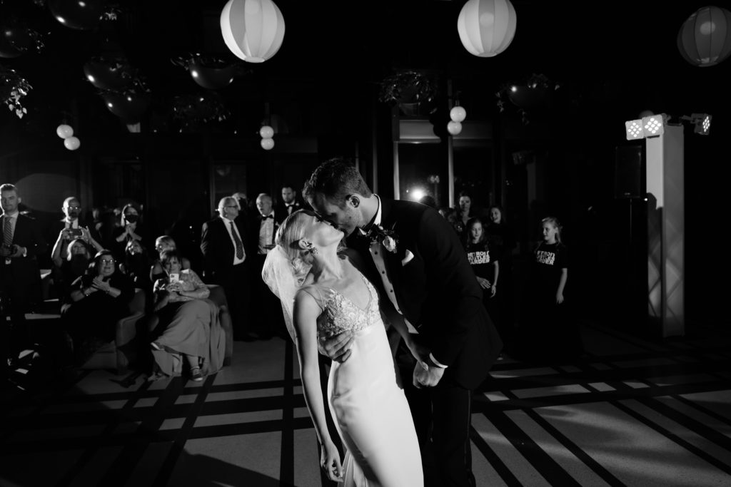 luxury wedding photography of the bride and groom sharing a kiss during a dance at their reception