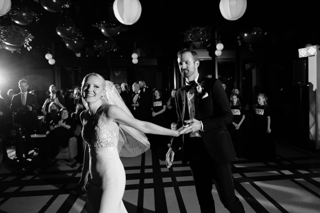 the bride leads the groom onto the dance floor at their shinola hotel wedding