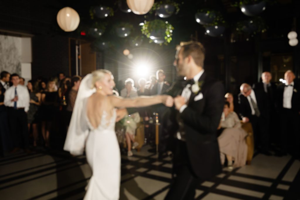 a blurry, film style photo from a detroit wedding photographer of the bride and groom on the dance floor