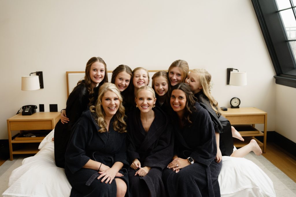 the bride smiles with the women of her wedding party while getting ready for her shinola hotel wedding