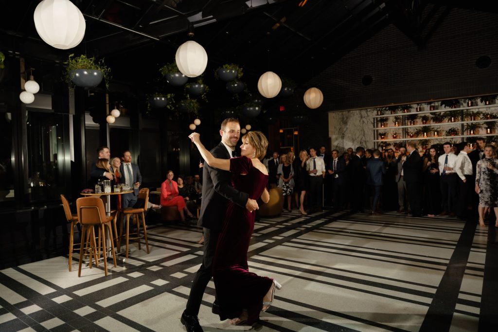 the groom dances with his mother at the reception of his shinola hotel wedding