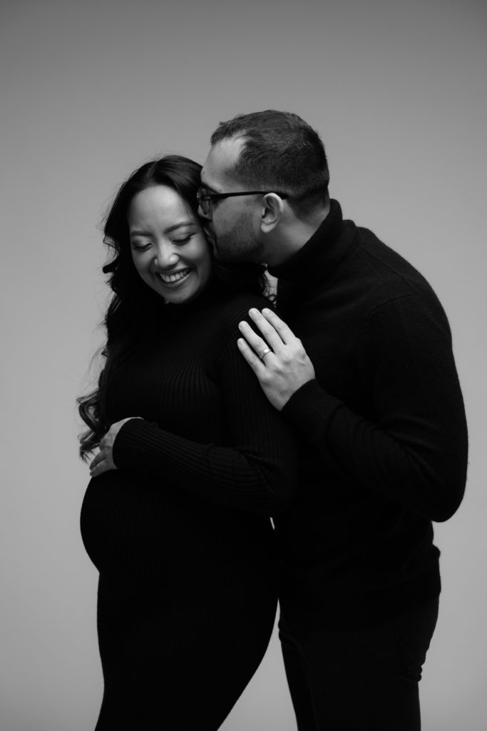 an expectant couple stand together in a session with a michigan maternity photographer