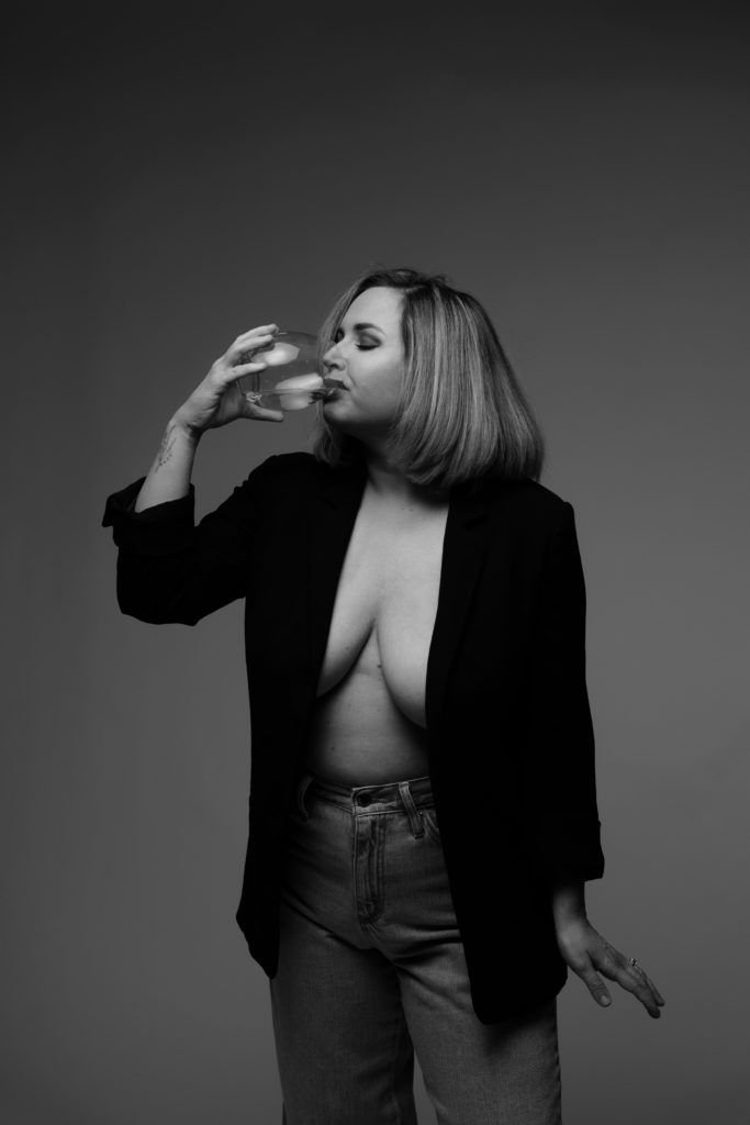 jo sips from a glass of wine during her editorial empowerment photoshoot