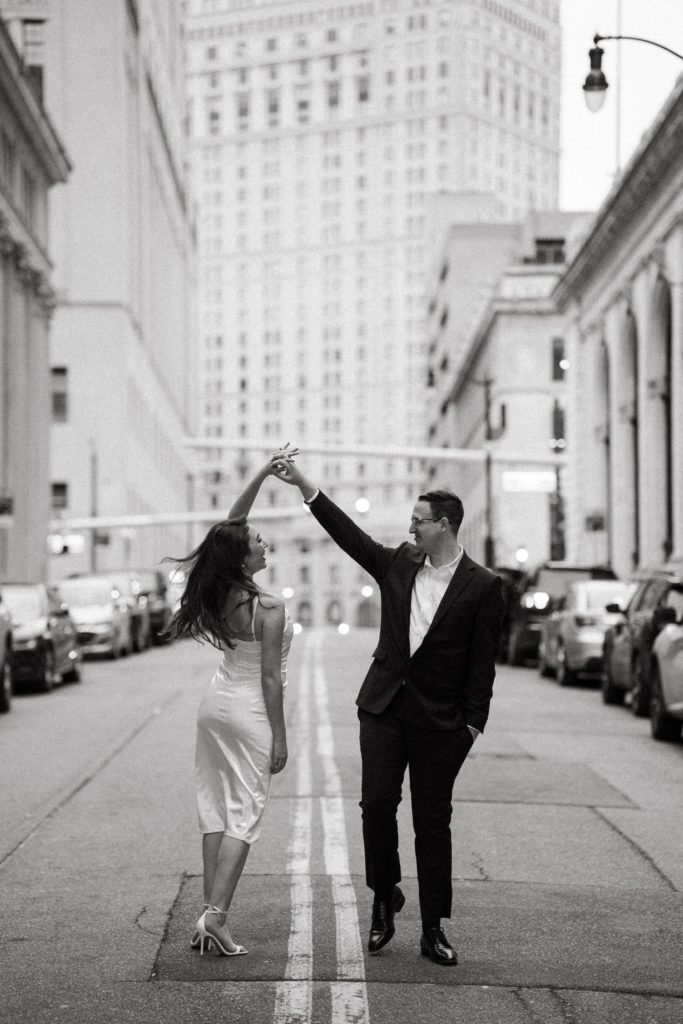 julia and drew dance in the street with their engagement photographer