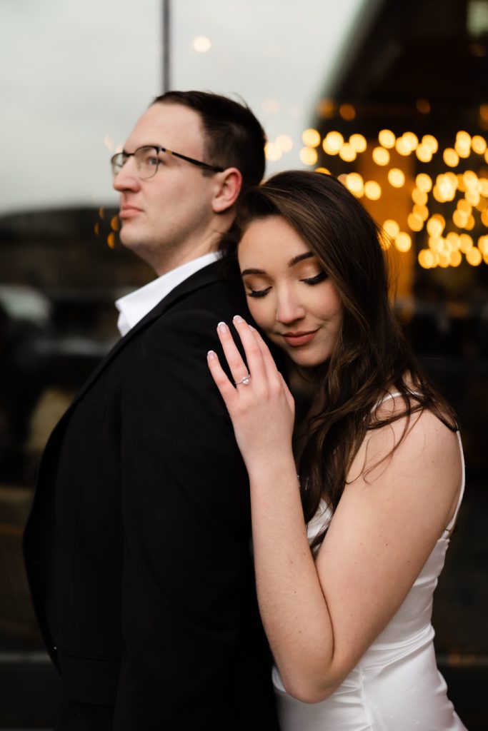 julia leans against drew during their engagement photoshoot