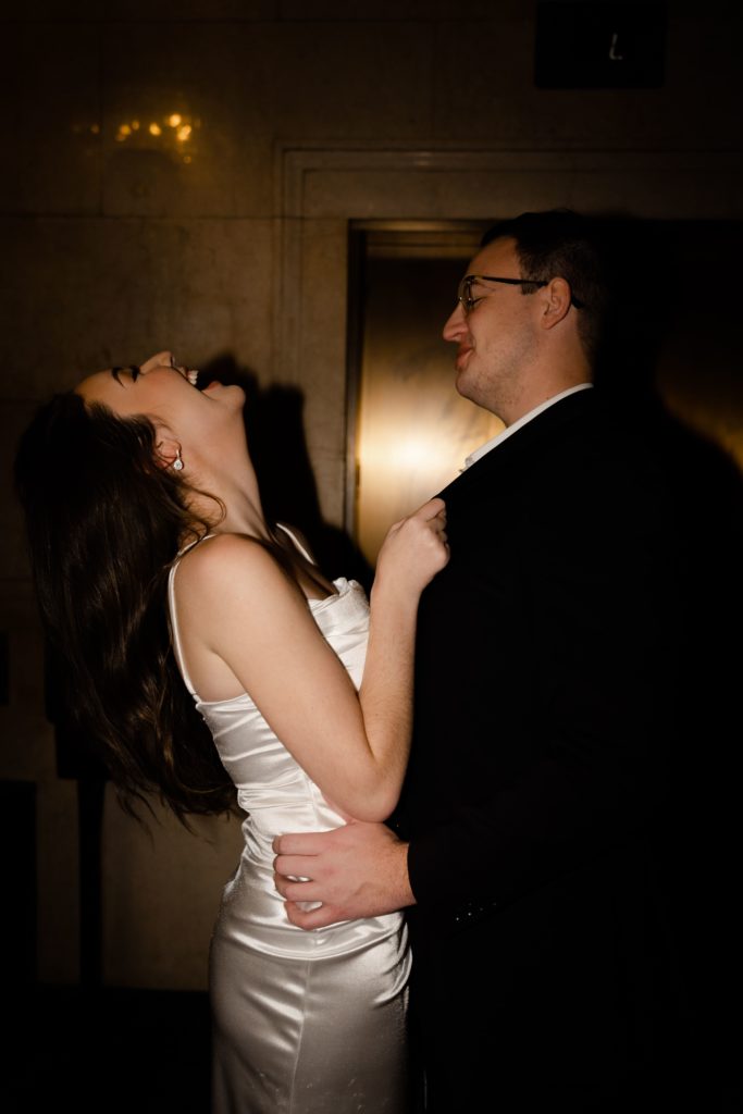 julia and drew laugh during the flash portion of their shoot with michigan engagement photographer