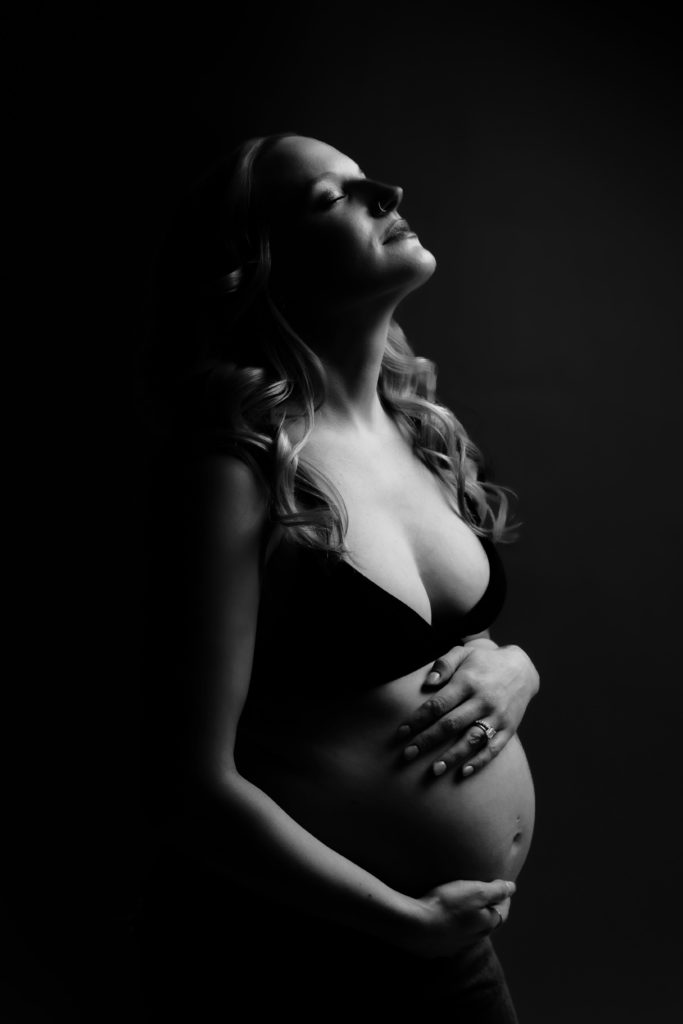 a black and white editorial lighted photo from a maternity session