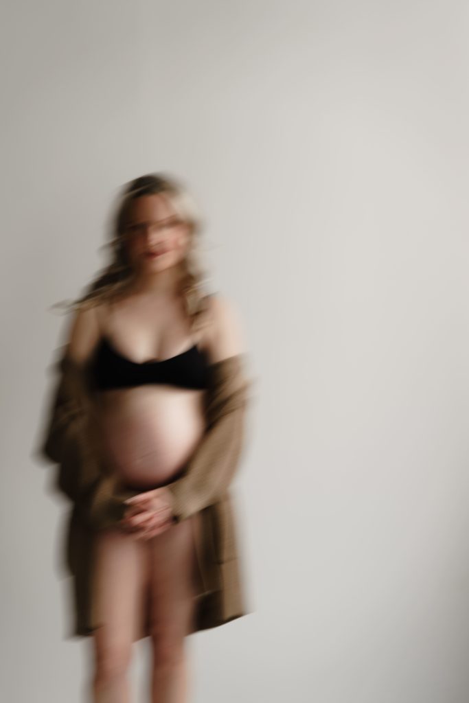 a cozy motion blur portrait in natural light from a session with michigan maternity photographer