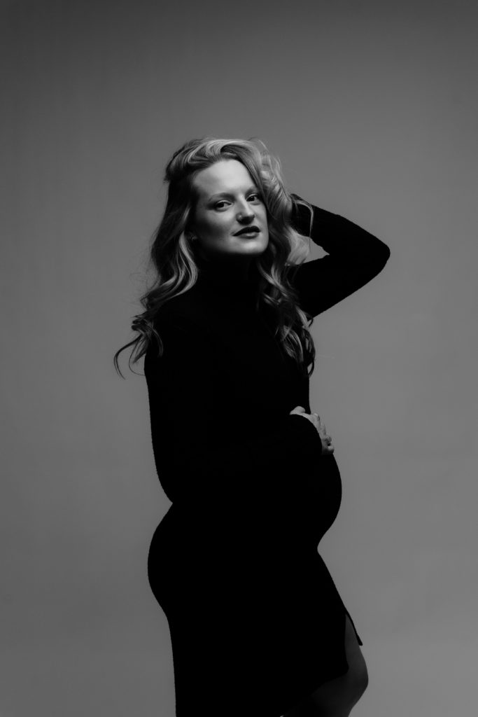 an editorial style photo of an expecting mother at a maternity photoshoot