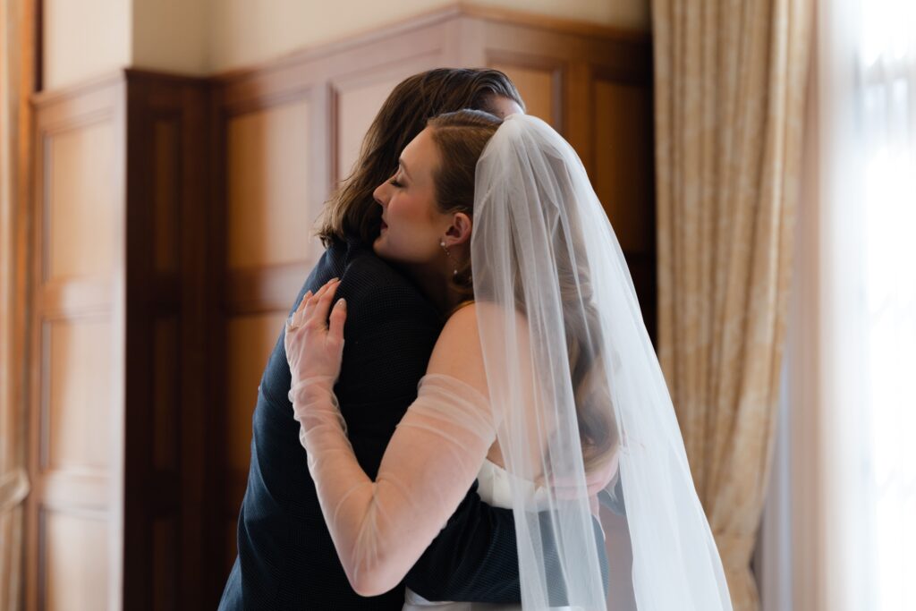 the bride and groom hug during their first look