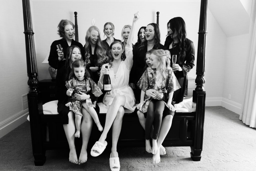 the bride celebrates with her bridesmaids and flower girls