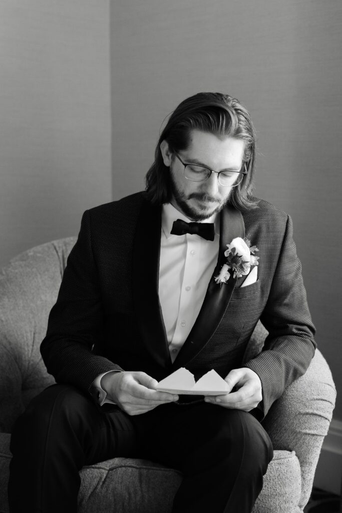 the groom reads a letter from the bride before their wedding ceremony