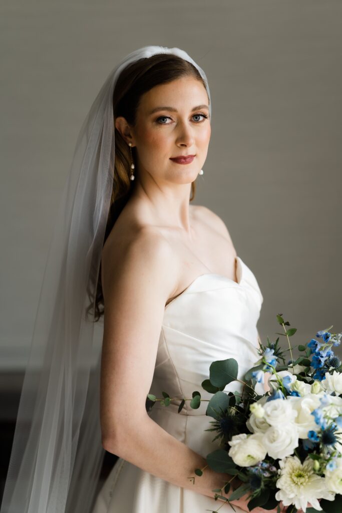 the bride looks fiercely at the camera before her wedding ceremony