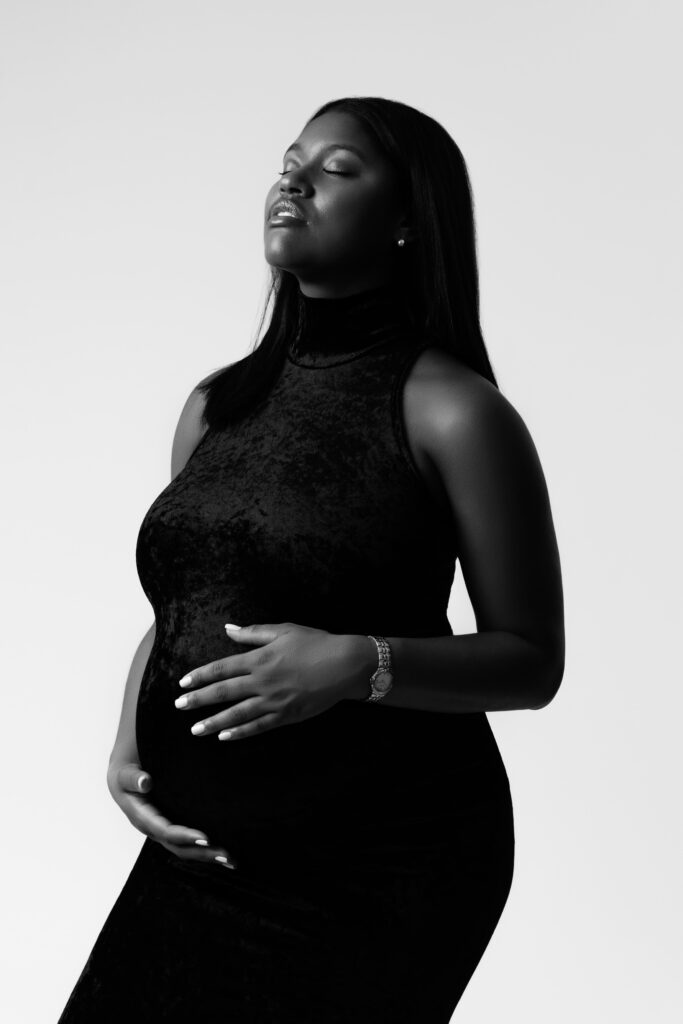 camille basks in the studio light with a michigan maternity photographer
