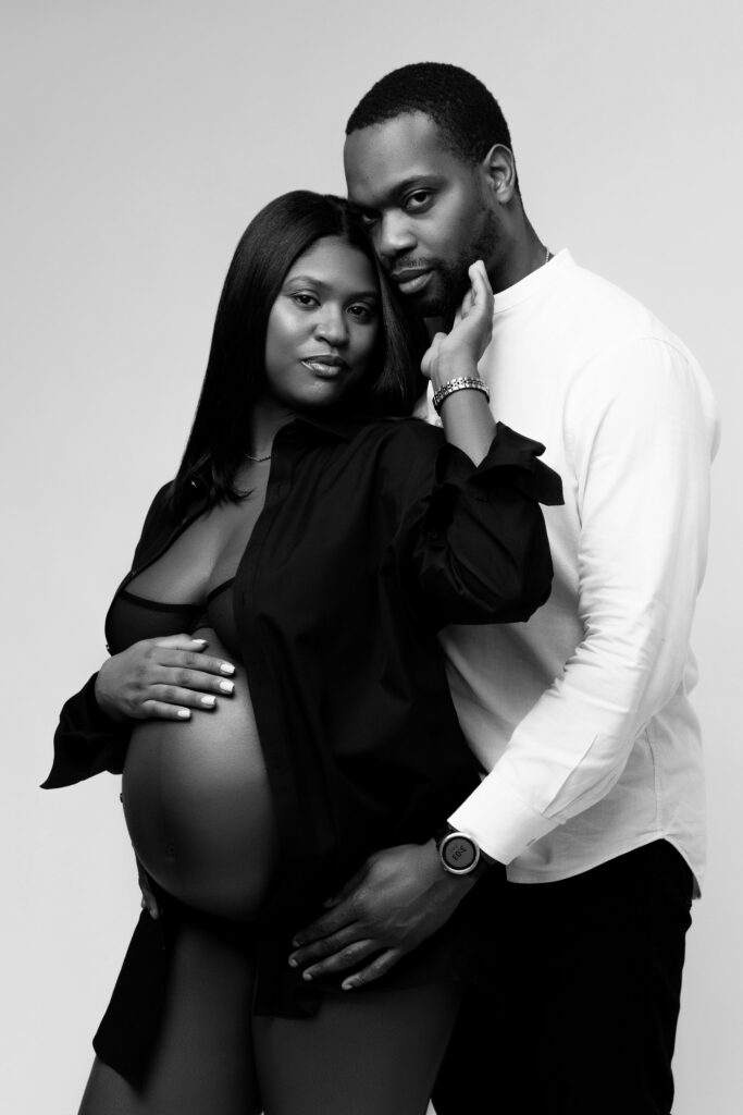 camille and david smile softly for maternity photos
