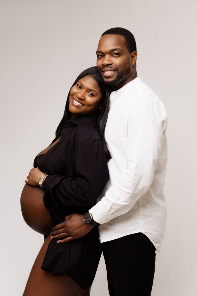 camille and david smile during a shoot with a michigan maternity photographer