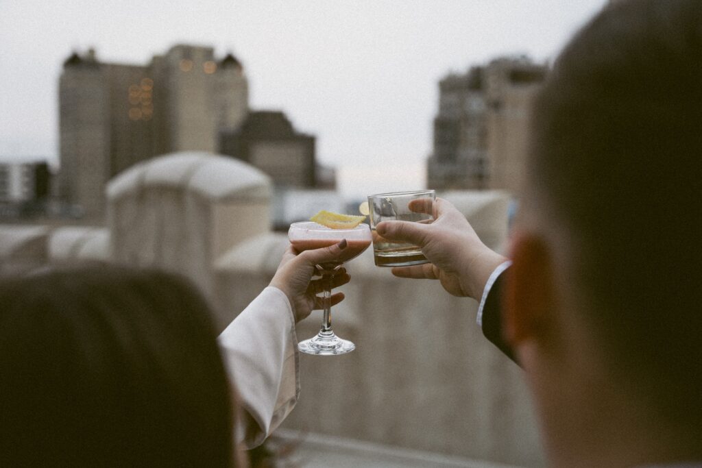 jane and john cheers their drinks during their detroit engagement photos