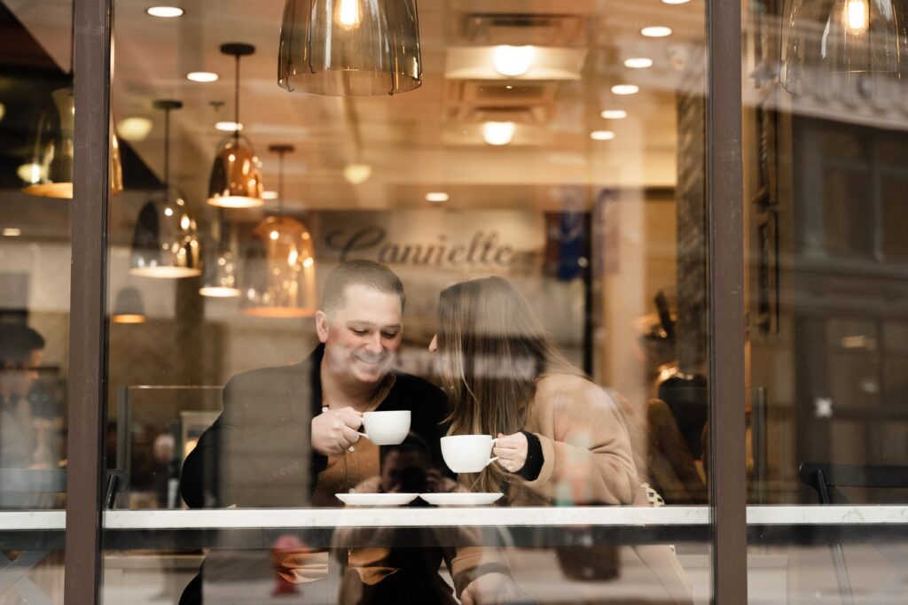 michigan engagement photographer captures jane and john through a window of a detroit coffee shop