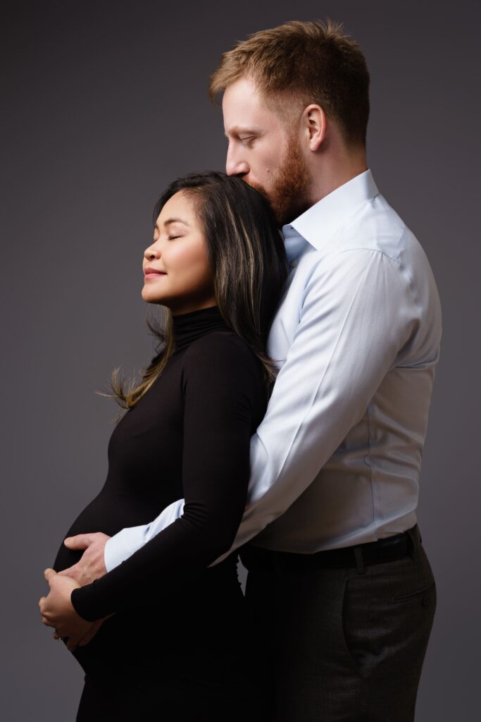 nat and andy lean into each other during maternity photos