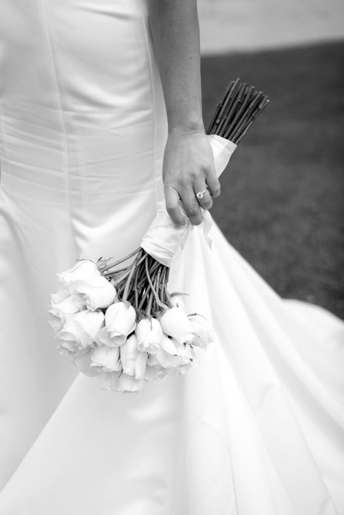 the bride holds her bouquet at her side