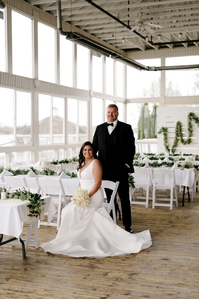 the bride and groom smile for bridal portraits in their open and airy elopement venue