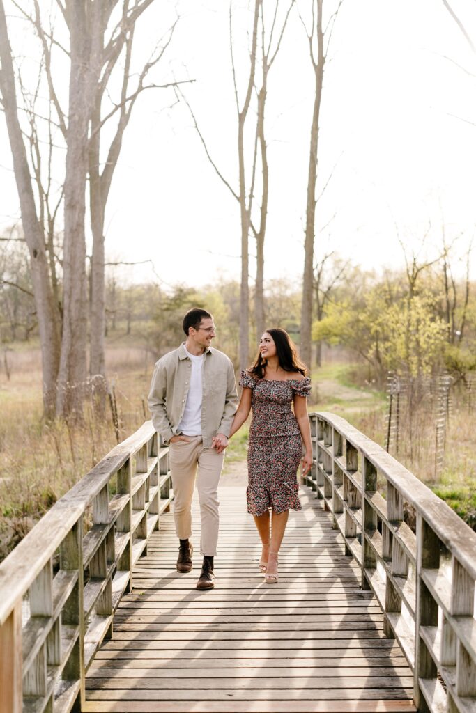 spencer and dalia walk together during their session with a michigan engagement photographer