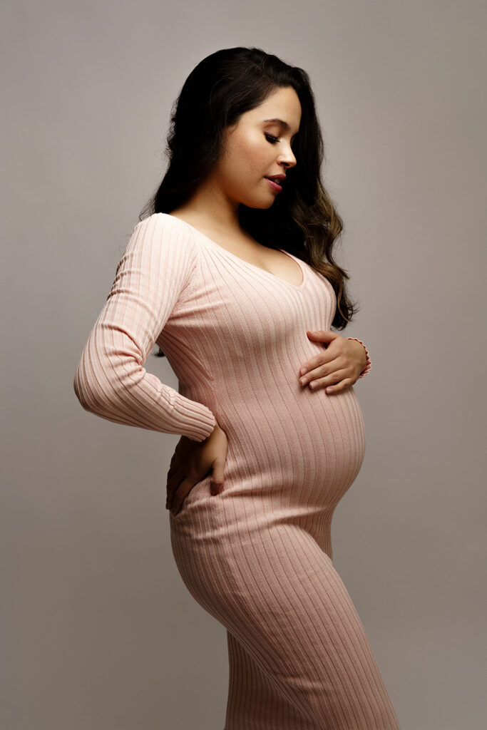 pregnant woman wearing pink sweater dress 
