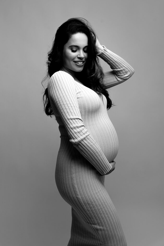 pregnant woman wearing sweater dress in black and white