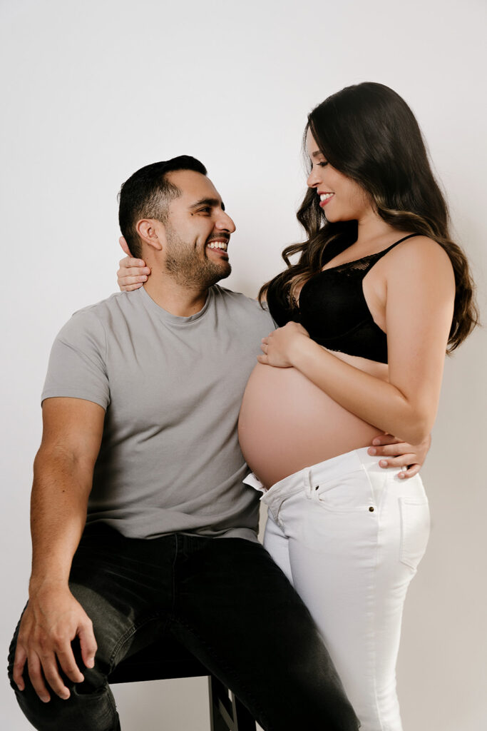 pregnant woman and husband smiling