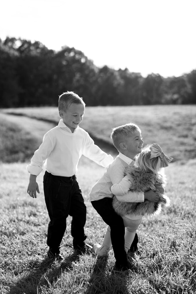 two boys and one girl siblings black and white portrait